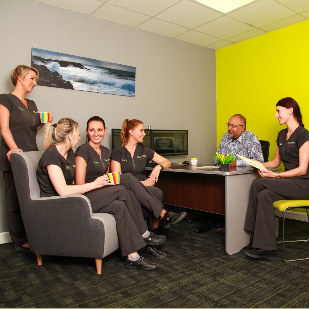 Ennis Braces Orthodontist Team Photo with Jeeves in Office